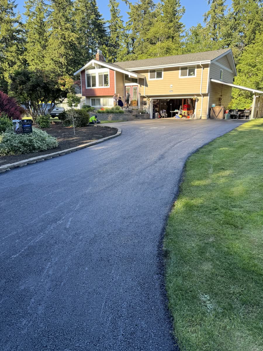 New residential asphalt driveway with clean hand-finished edges